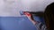 Painting a ceiling with paint brush