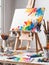 Painting easel with colorful paints and brushes