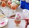 Painting Easter eggs with paintbrush