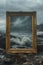 Painting in a golden antique frame on the seashore, rocks, waves nature, dark atmosphere