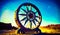 Painting of large wheel in desert with mountains in the background. Generative AI