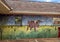 Painting of a longhorn steer on the brick sidewall of a gas station on Route 66 in Luther, Oklahoma.