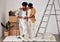 Painting, pregnancy or black couple hug in home renovation, diy or house remodel together by apartment ladder. Teamwork