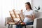 Painting While Pregnant. Happy Young Expecting Woman Drawing Picture On Easel