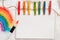 Painting of rainbow on notebook or sketch book with paintbrush on wooden planks for
