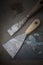 Painting Spatulas on Dirty Workbench