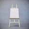 Painting stand wooden easel with blank canvas poster sign board isolated on concrete texture background