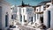 painting of a sunlit traditional greek village street with ancient white houses in summer sunlight