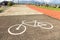 Painting of a white bicycle figure on a concrete road