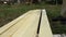 Painting woodwork outside. hand holding a brush applying varnish paint on a wooden surface.