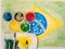 Paints lids,brushes and and stained fabric on the brazil flag wa