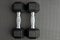 Pair of 15-pound dumbbells on a black gym floor