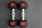 Pair of 15-pound dumbbells on a black gym floor, red sparkly hearts