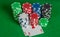 Pair aces and poker chips stack on green table