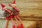 Pair of adorable and cute Christmas Elves - boy and girl - sitting in rustic wooden table. With copy space.