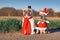Pair of adult and puppy French Bulldog dogs dressed up with funny snowman and santa Christmas costumes