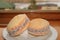 A Pair of Alfajores, Traditional Latin American Filling Cookies Served on Window Side Wooden Table, Ushuaia, Argentina