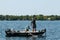 Pair of Anglers Fishermen in Boat Landing and Netting a Smallmouth Bass