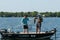 Pair of Anglers Fishermen in Boat Landing and Netting a Smallmouth Bass
