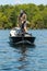 Pair of Anglers Fishermen Fish for Bass in a Boat During the Summer