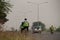 pair of asian cyclists, a man and woman riding on road in Golden