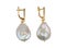 Pair of baroque pearl gold earrings isolated on white background