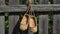 A pair of bast shoes hanging on a wooden fence