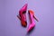 Pair of beautiful shoes on lilac background, top view