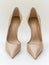 Pair of beige leather high heel shoes.