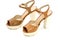 Pair of beige womens high heeled shoes from patent leather on white background.