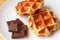 Pair of Belgian Liege Waffles with Chunks of Belgian Dark Chocolate on a White Plate