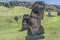 Pair of big underground sculture of moai on the extinct volcano Rano Raraku