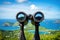 a pair of binoculars facing a scenic vista