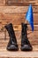 Pair of black boots with european union flag on wood.