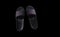 Pair of black indoor slippers isolated on black background