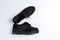 A pair of black shoes with shiny inserts on thick soles on a white background