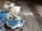 Pair of blue ceramic bowls full breakfast cereal with fresh blueberries and milk