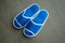 A pair of blue disposable slippers with soft foam texture for in