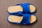 Pair of blue home slippers with leather insoles. Top view.