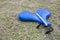 A pair of blue kick pads on the ground. Used for taekwondo or karate practice