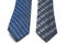 A pair of blue and olive green patterned men neck ties