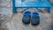 Pair of blue rubber shoes in front of blue stairs