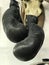 A pair of boxing gloves hang from the wall of a barber shop