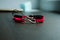 Pair bracelets in black and red with infinity. Handmade woven bracelets. Handmade decorations. Background with beads with hearts