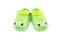 Pair of bright green children`s clogs isolated on the white