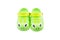 Pair of bright green children`s clogs isolated on the white