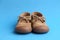 Pair of brown children`s shoes on blue background