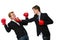 Pair of businessmen boxing on white