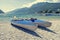 Pair of canoe lying on pebble beach.