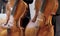 Pair of cellos in an oblique vertical position approximately parallel